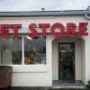 Picture of pet store front, with the CHRS logo's "Crossley Pup" in the front window